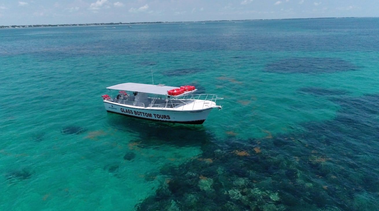 Aerial view of the Transparensea stopped over a patch reef in turquoise water