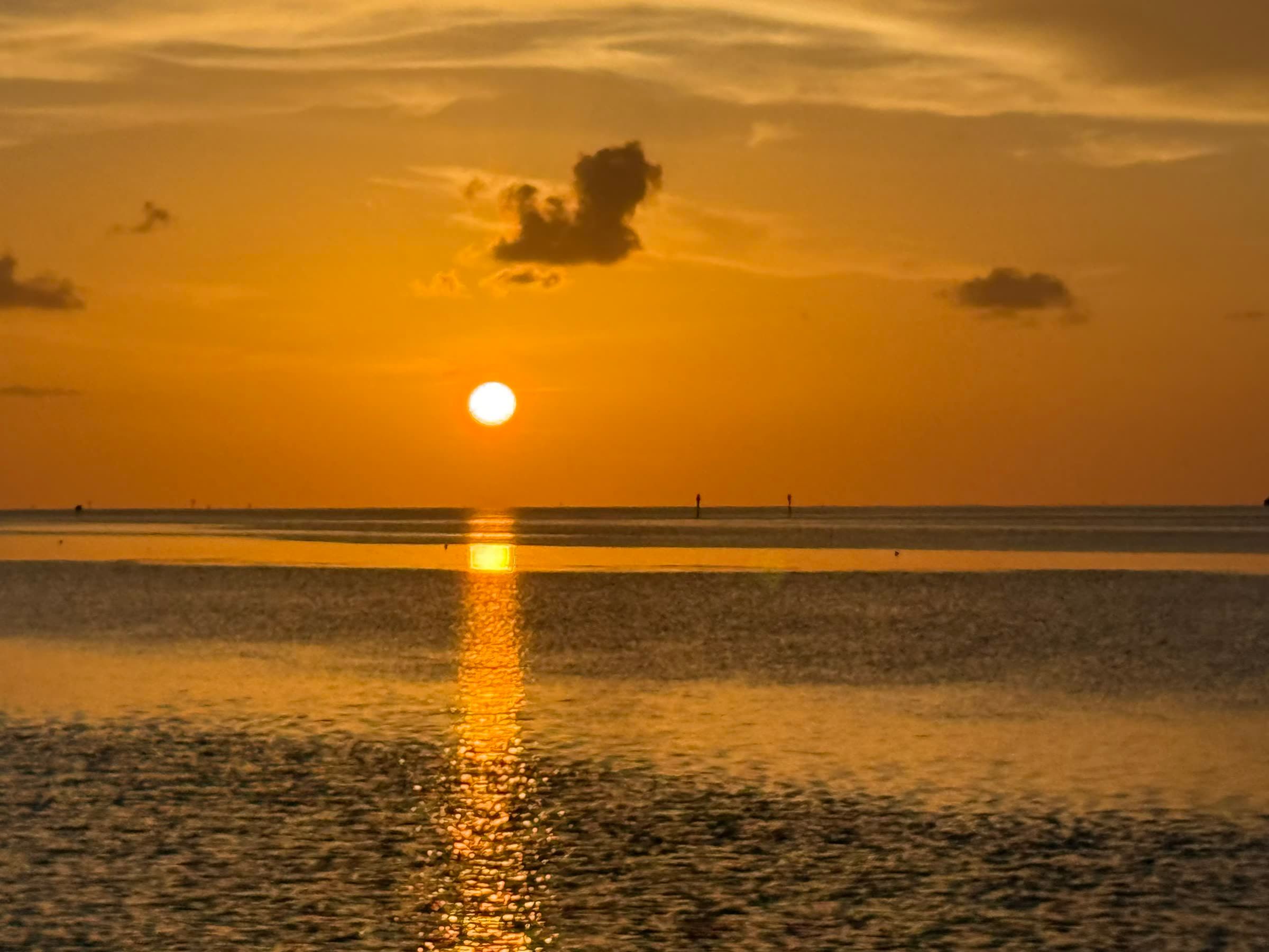The sun setting over Florida Bay off Islamorada, its reflection running across the water toward the boat