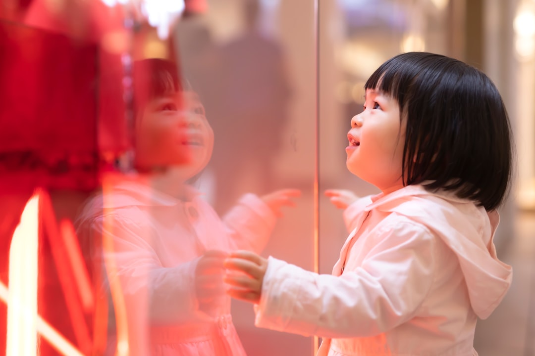 children looking through a glass viewing panel at coral and fish - marine life tours